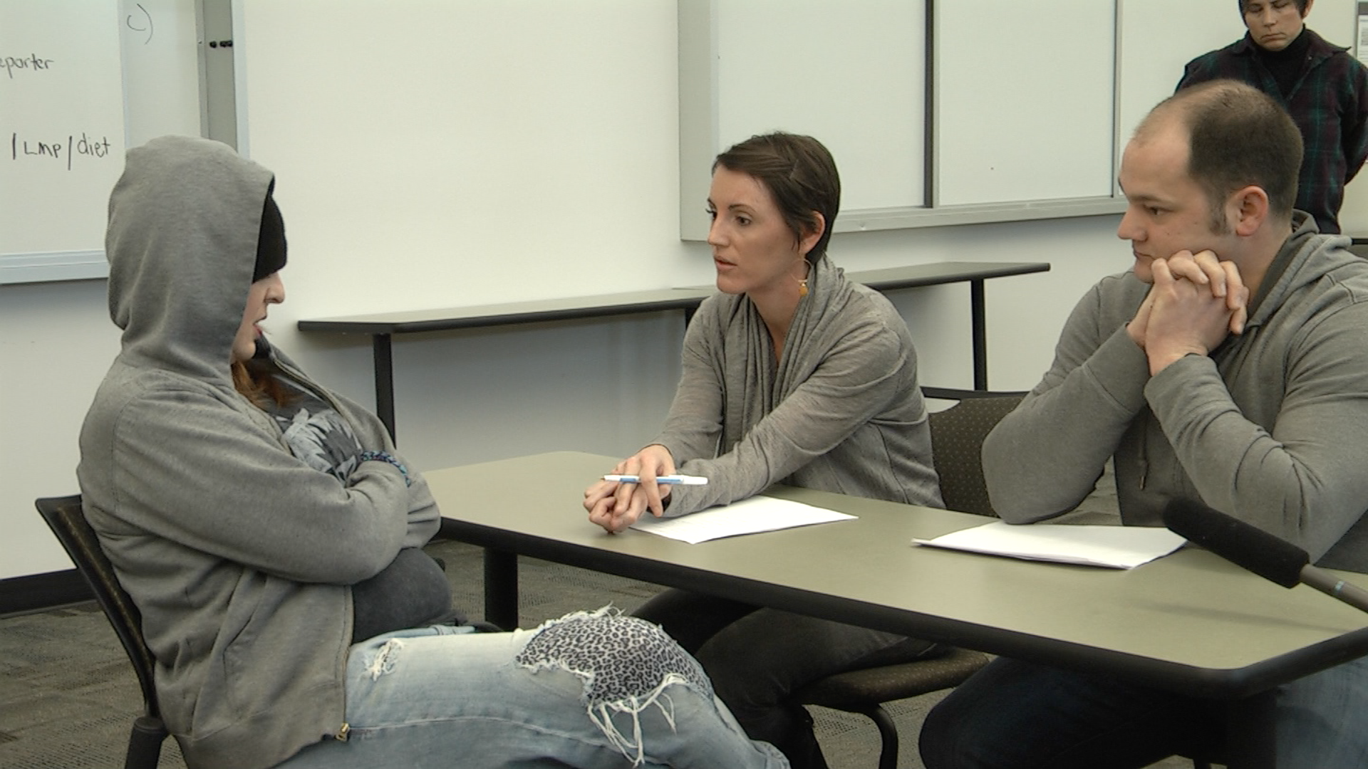 Students speak to an actor as a sullen teen